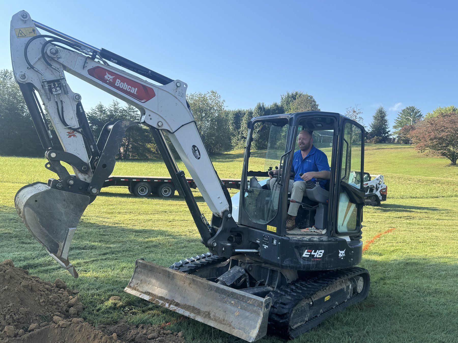 Compact excavator used for septic excavation and site work.