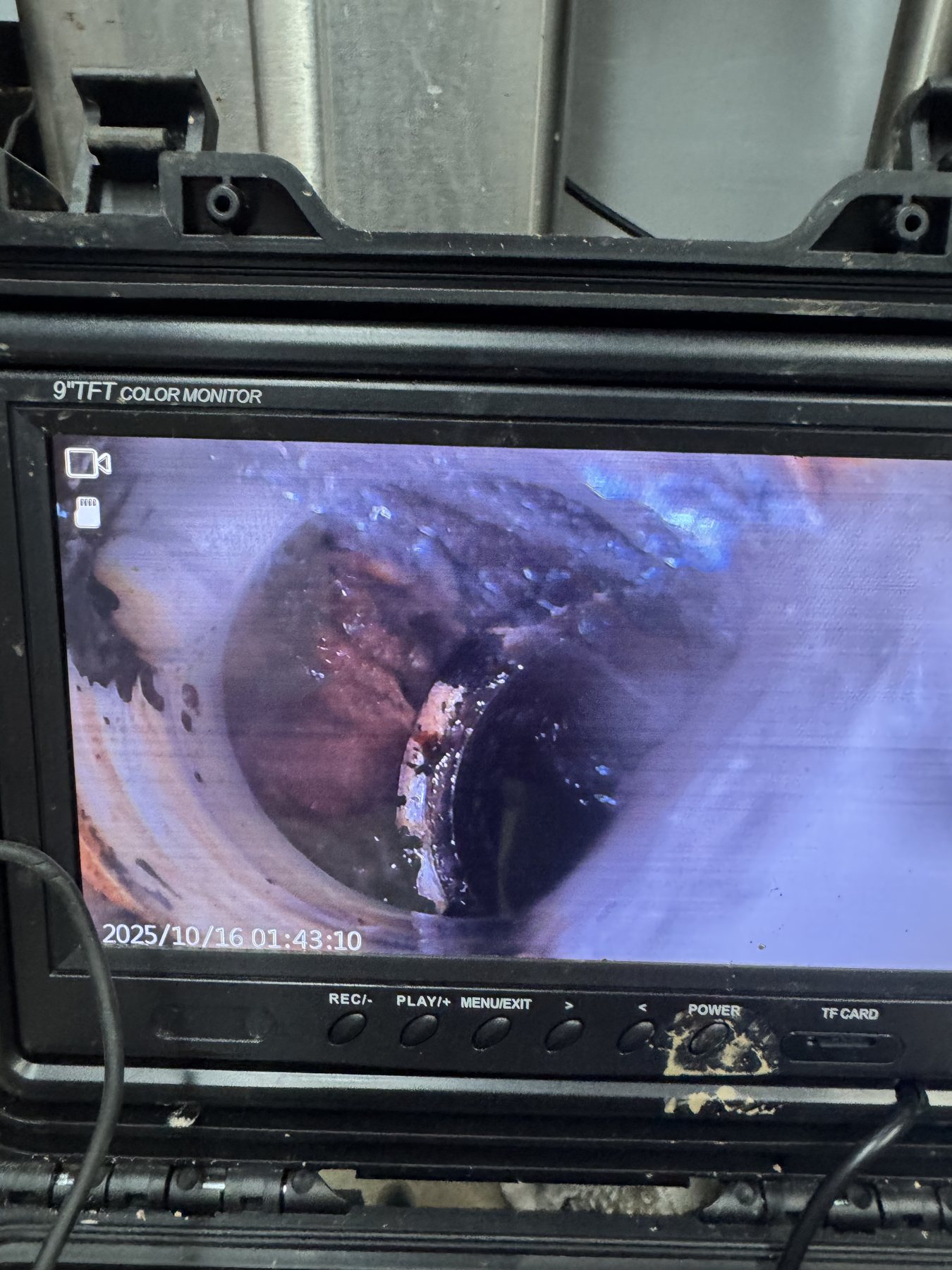 Sewer camera monitor showing the inside of a septic or drain line.