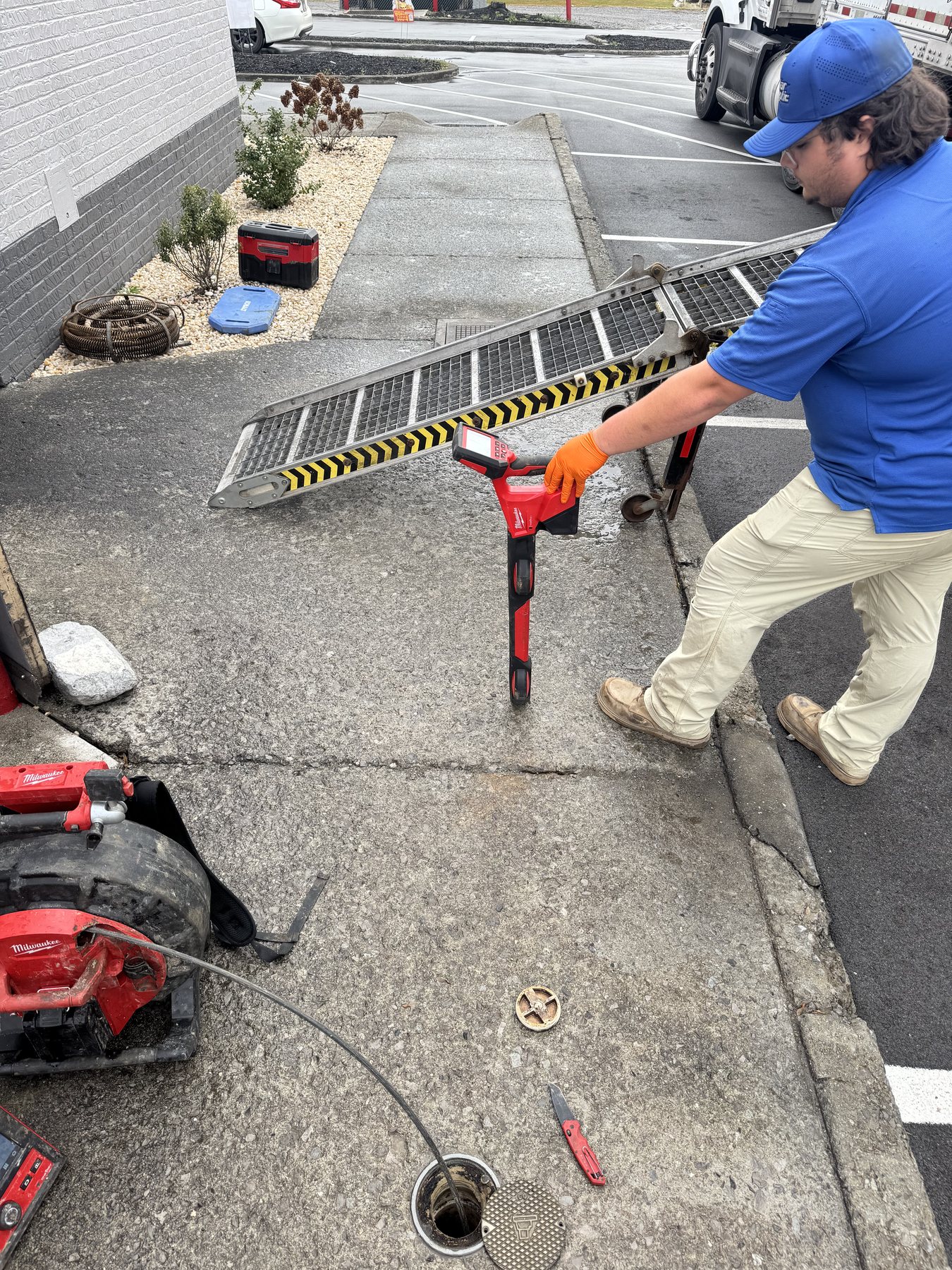 Star Septic technician using a locating tool to trace an underground line.