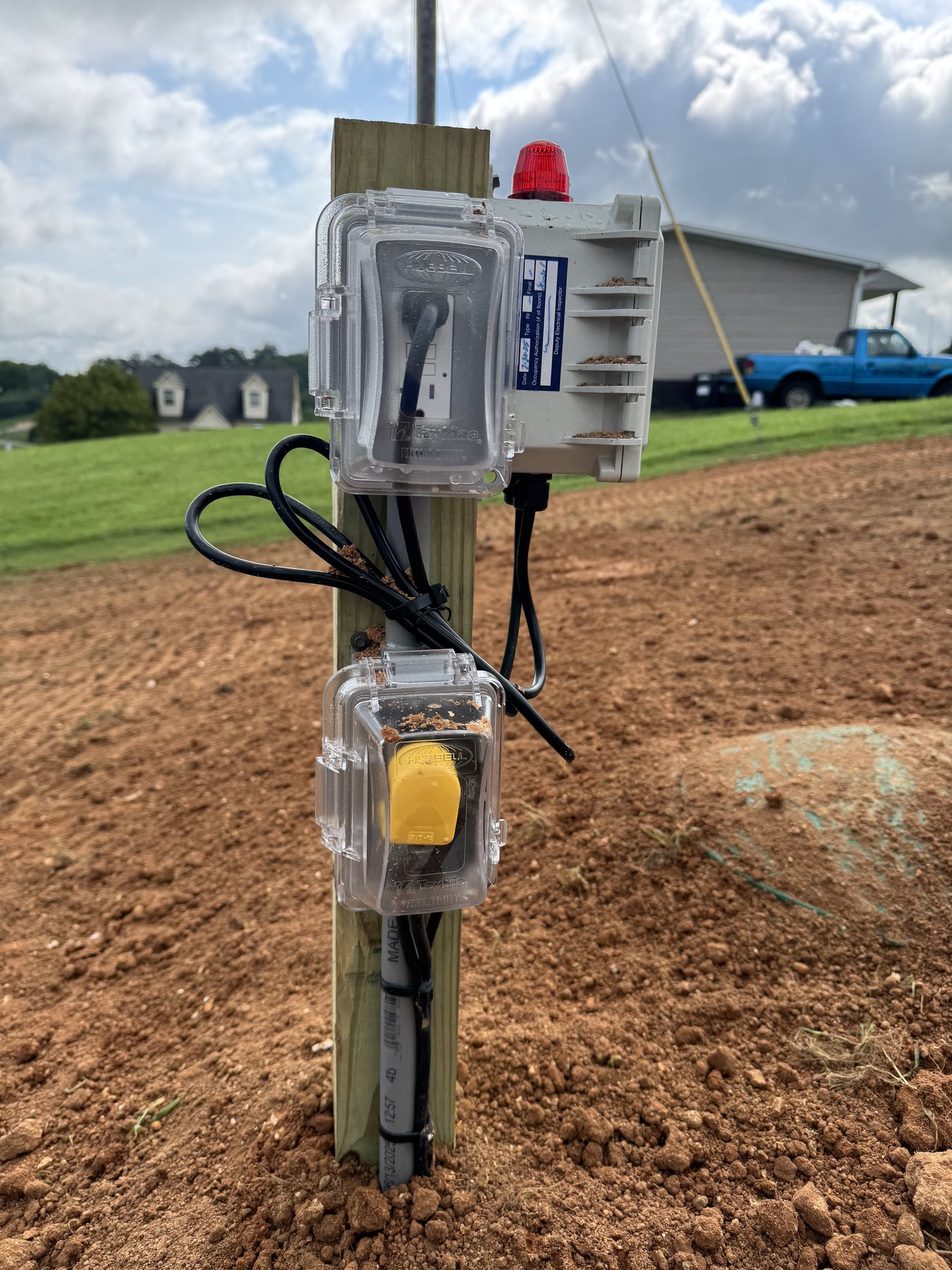 Septic pump system controls installed beside a rural septic field.