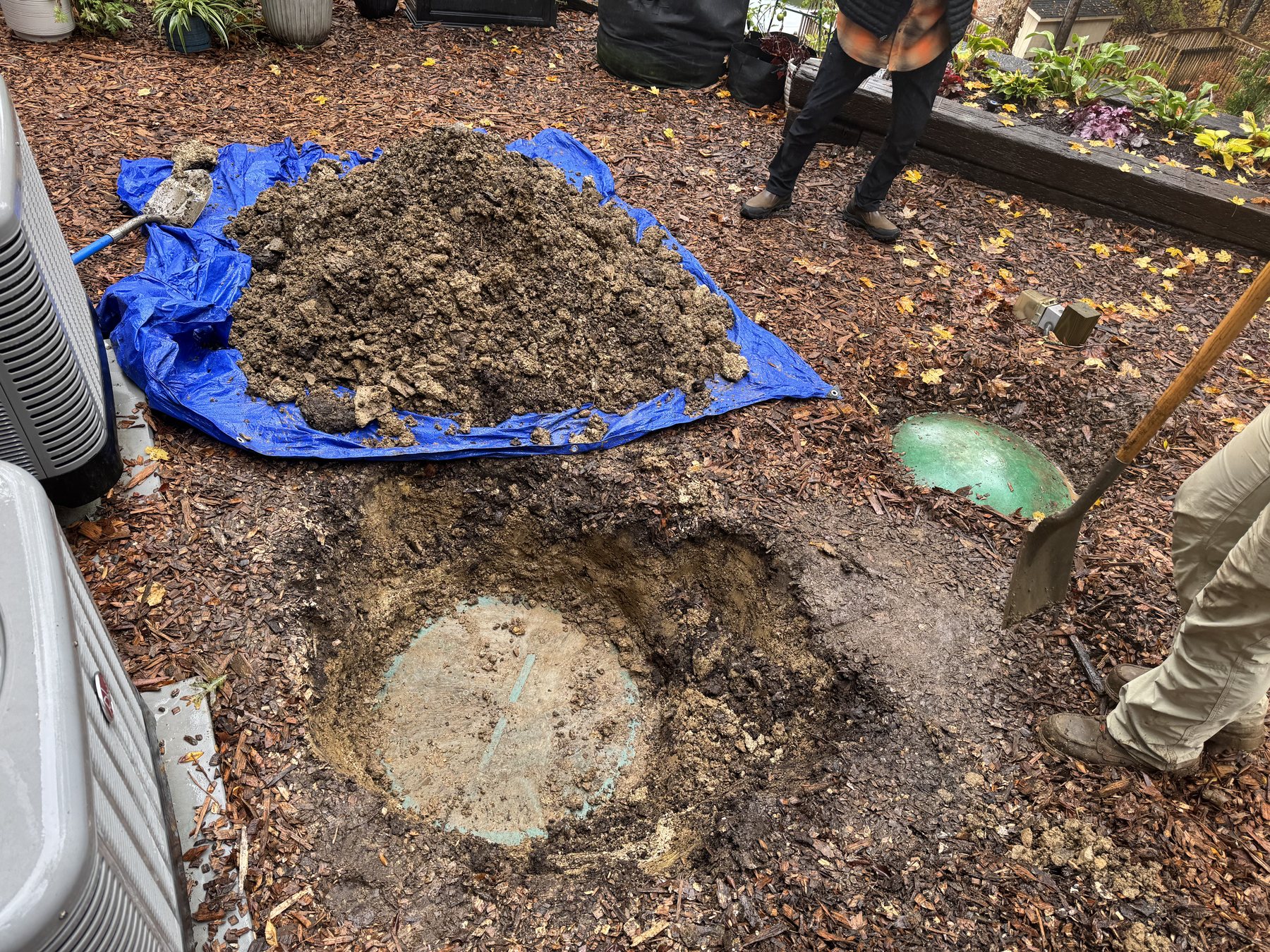 Star Septic crew exposing a septic tank during excavation work.