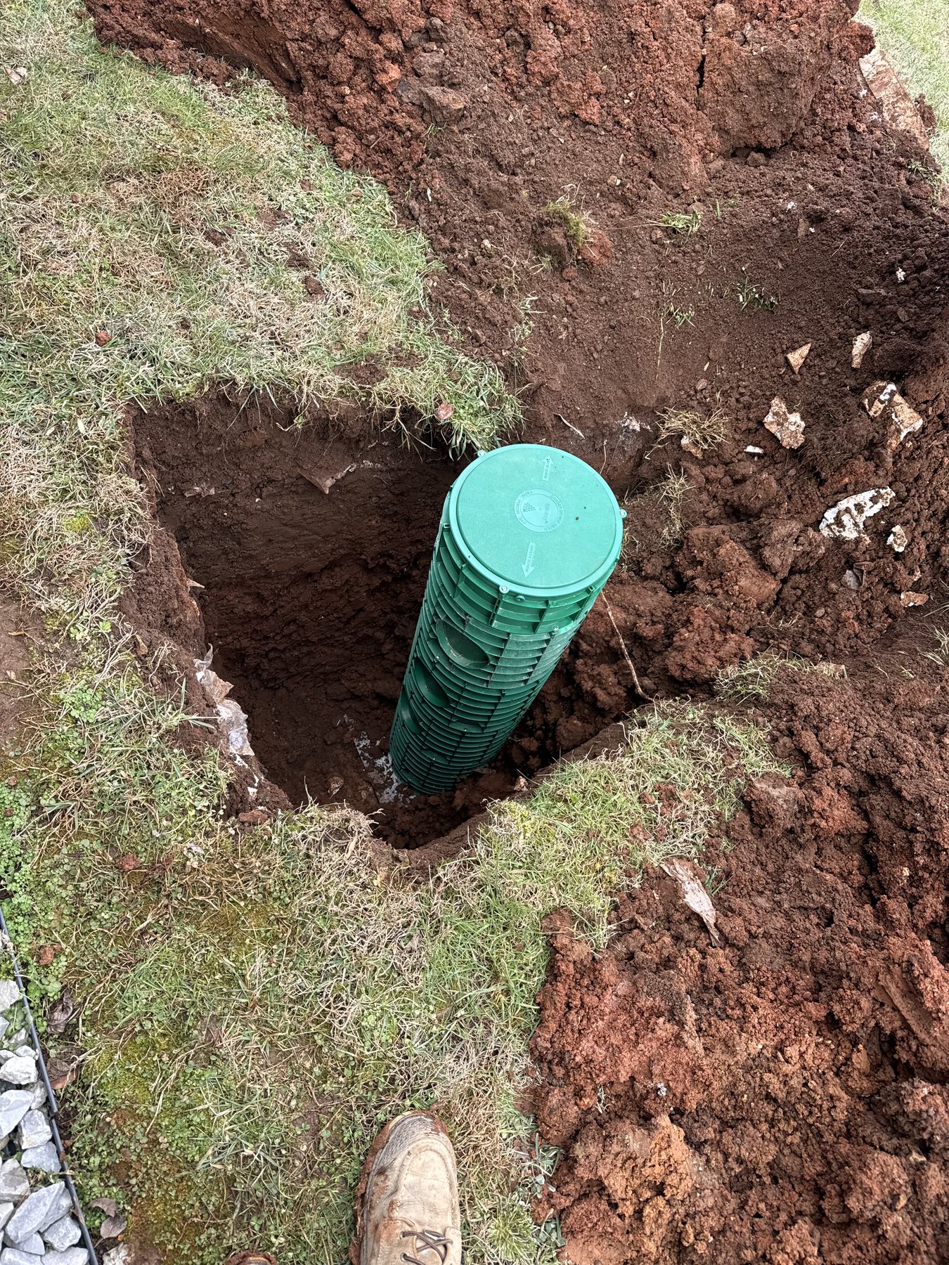Green septic riser installed above a septic system access point.