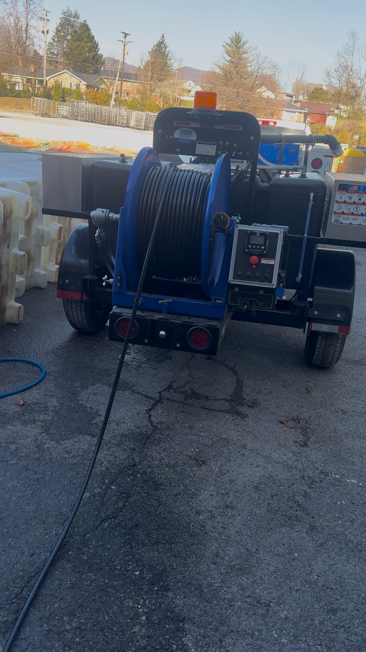 Trailer-mounted sewer jetter used for commercial sewer jetting and line cleaning.